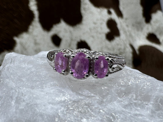 Pink Sapphire and Sterling Silver Ring on white rock with cowhide background