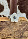 Load image into Gallery viewer, Vintage Mother of Pearl Flower Ring with Sapphire Stones on wood block with cowhide background
