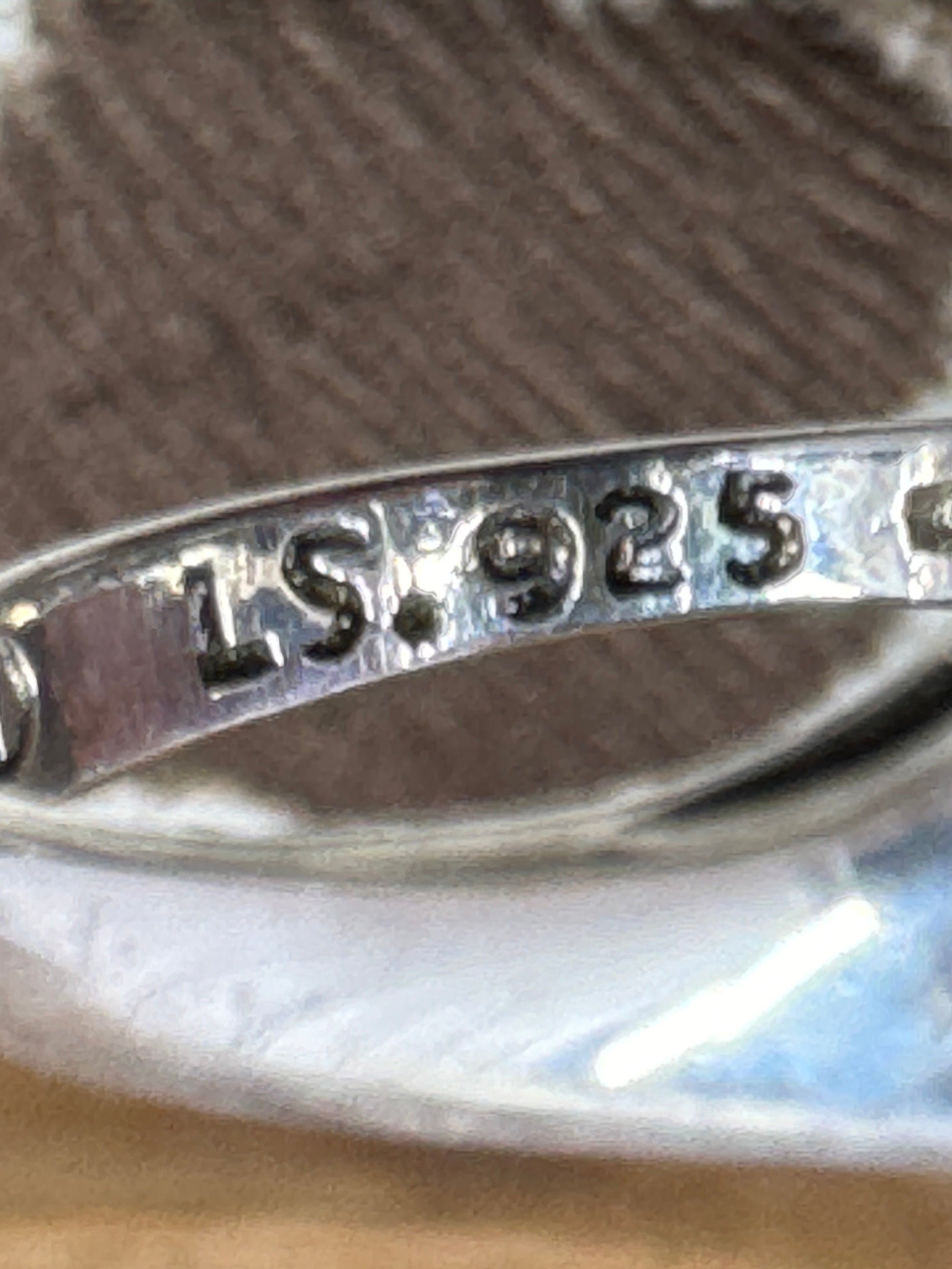 Inside of ring with 925 ST mark on brown background