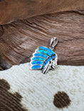 Load image into Gallery viewer, Indian Chief Head Pendant against wood and cowhide background
