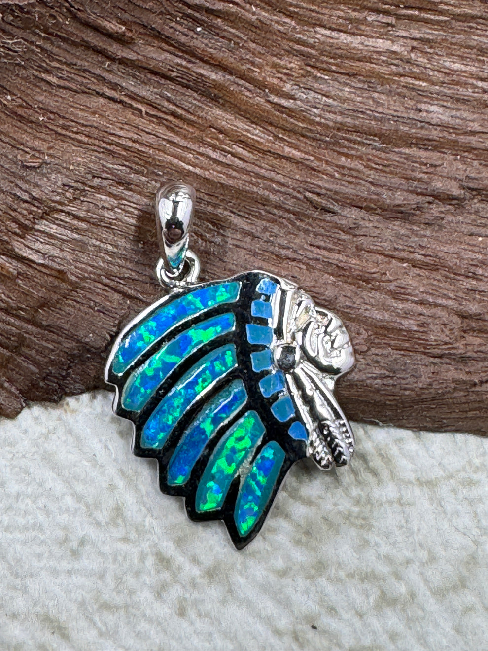 Indian Chief Head Pendant against wood background