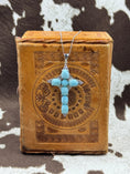 Load image into Gallery viewer, Larimar Cross with Sterling SIlver Chain on leather box with cowhide background
