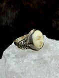 Load image into Gallery viewer, Bali Bone Ring "Face of the Moon" on white rock with dark background
