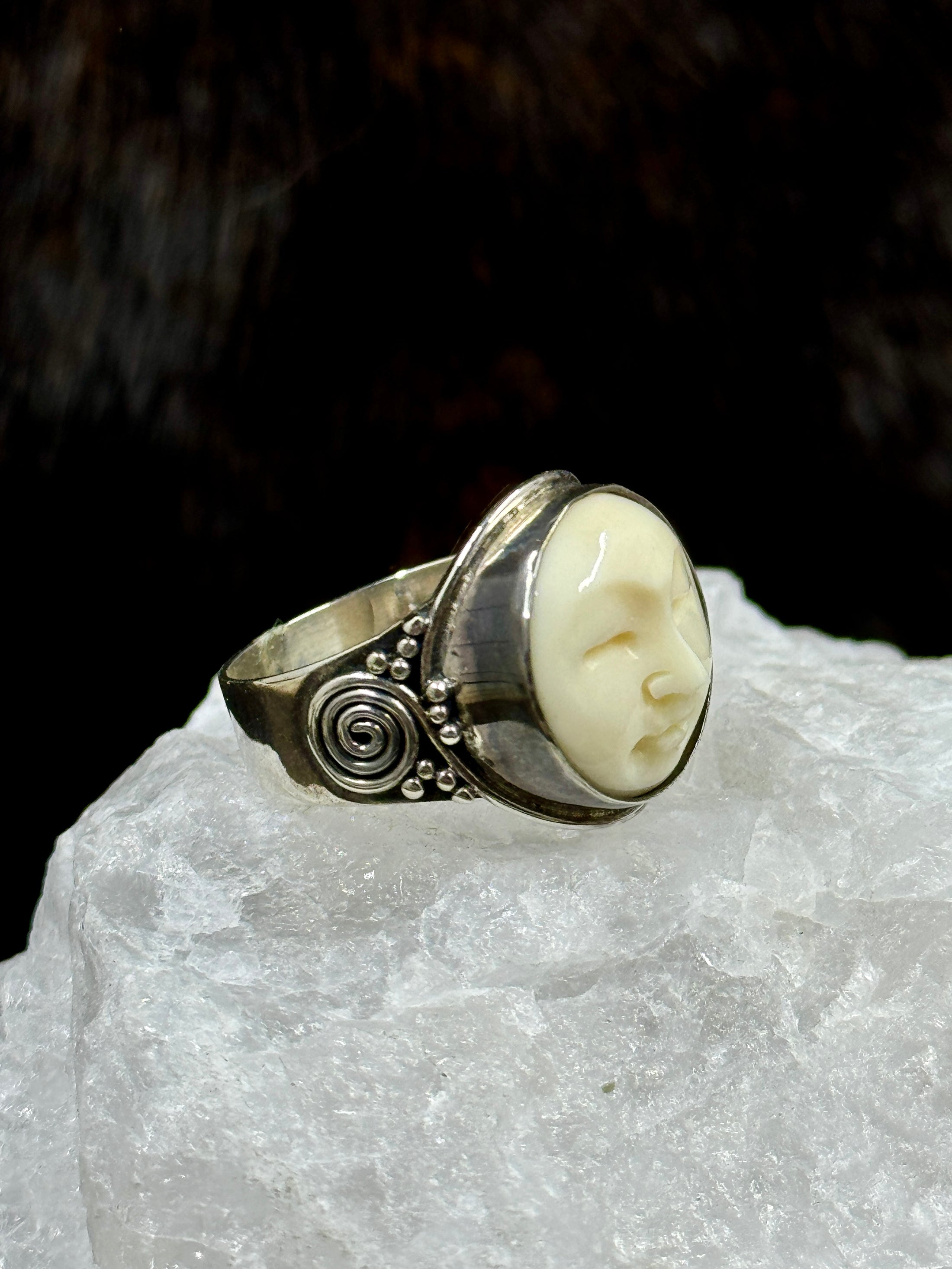 Bali Bone Ring "Face of the Moon" on white rock with dark background