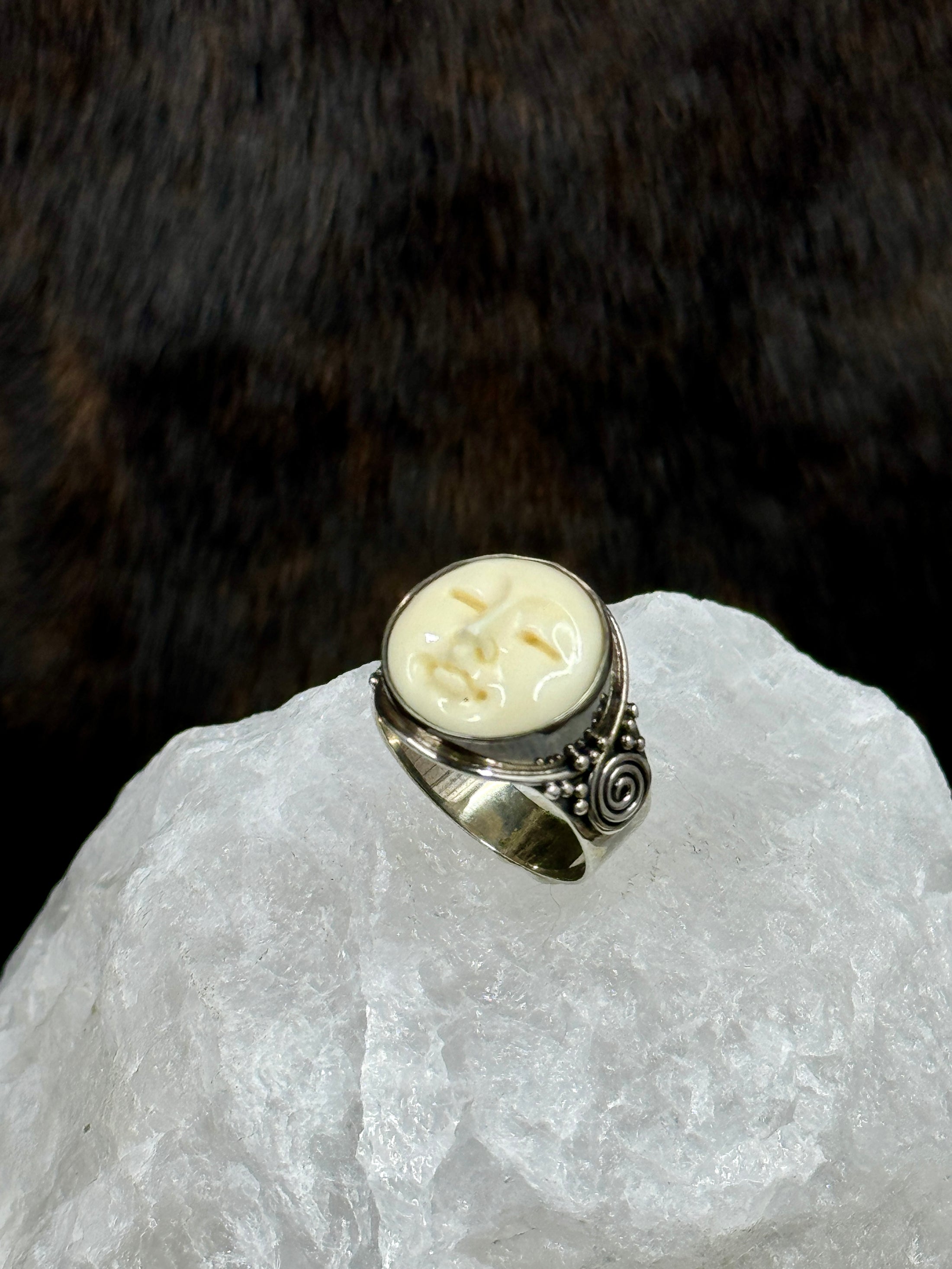 Bali Bone Ring "Face of the Moon" on white rock with dark background