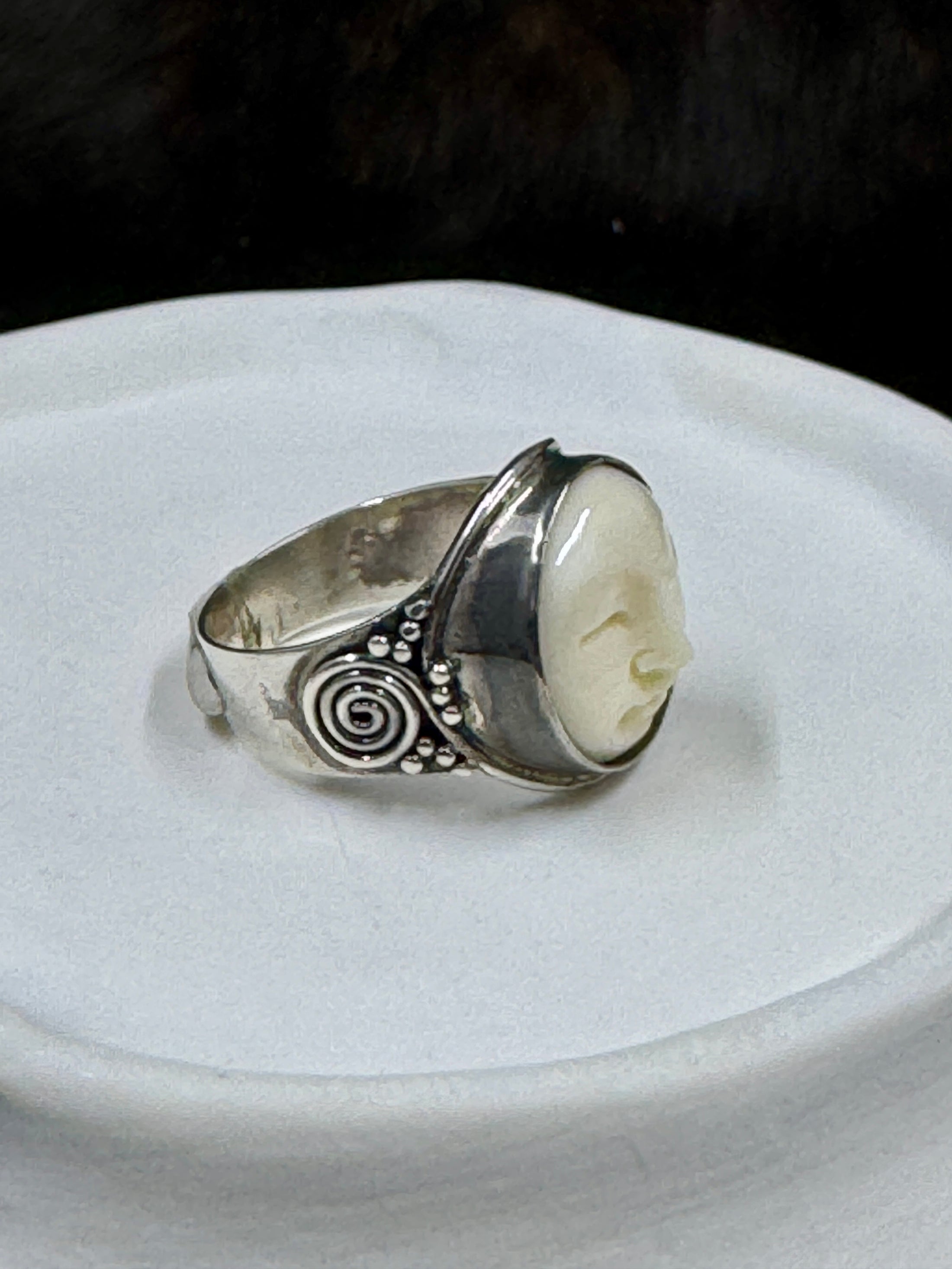 Bali Bone Ring "Face of the Moon" on white rock with dark background