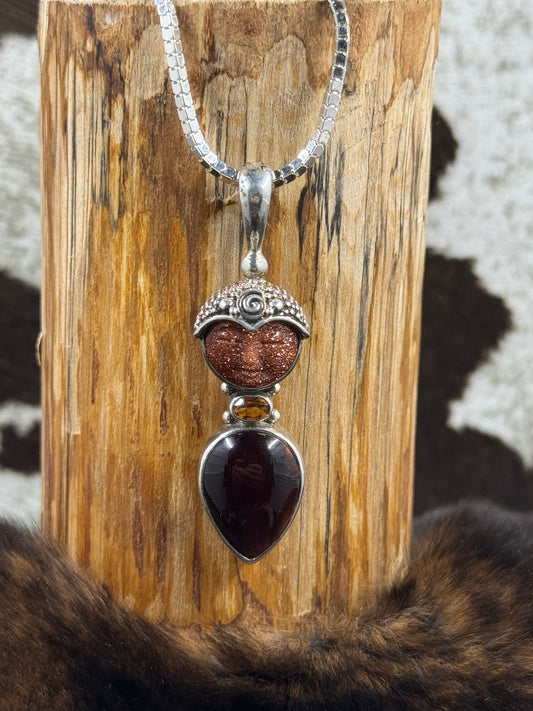 Sajen Goldstone and Citrine Pendant on cowhide background