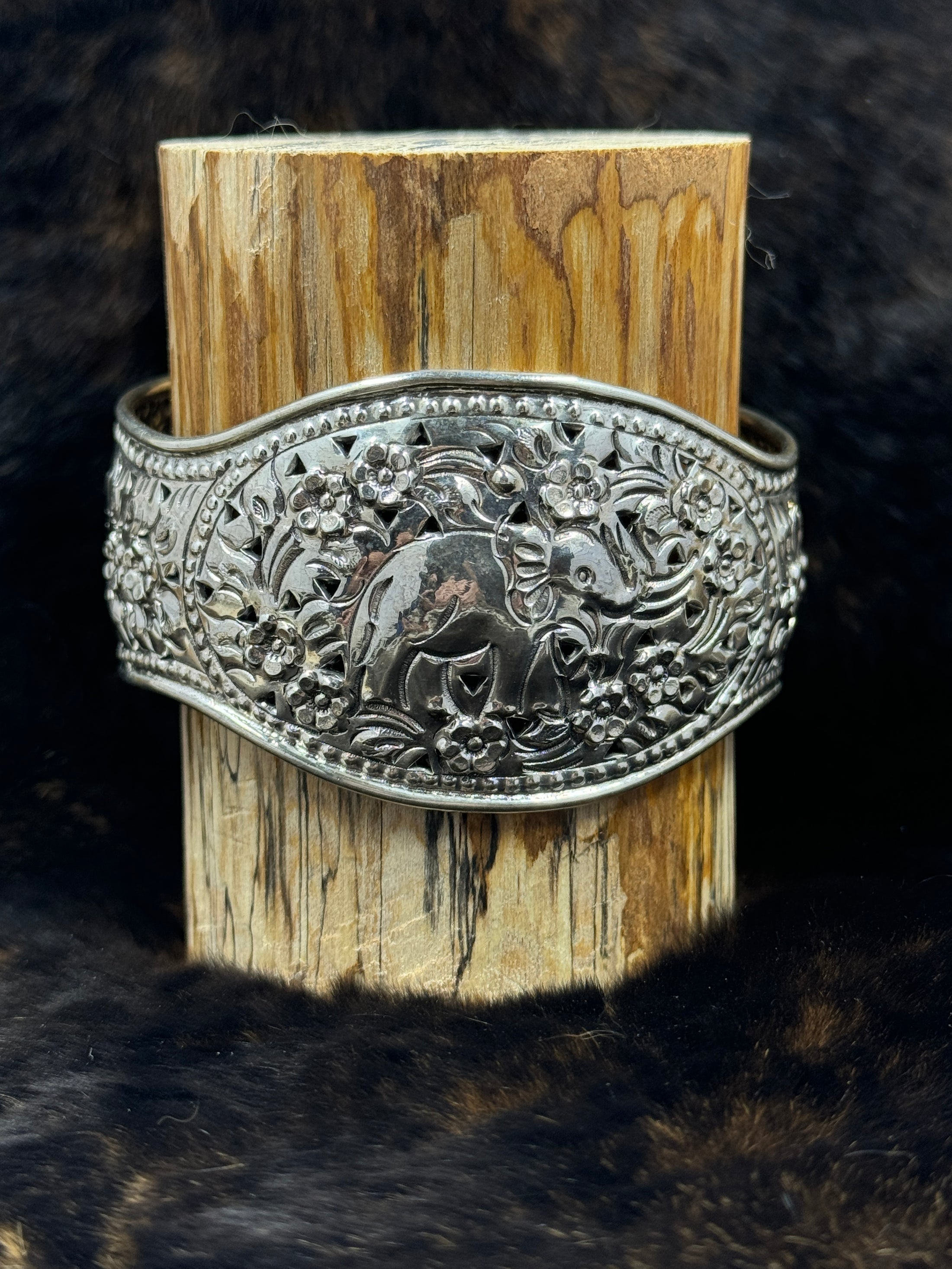 Elephant Bracelet Cuff wrapped around wood block with fur background