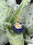 Bild in Galerie-Betrachter laden, Vintage 14K World Glob Inlay Charm Pendant by Michael Anthony sitting on green plant
