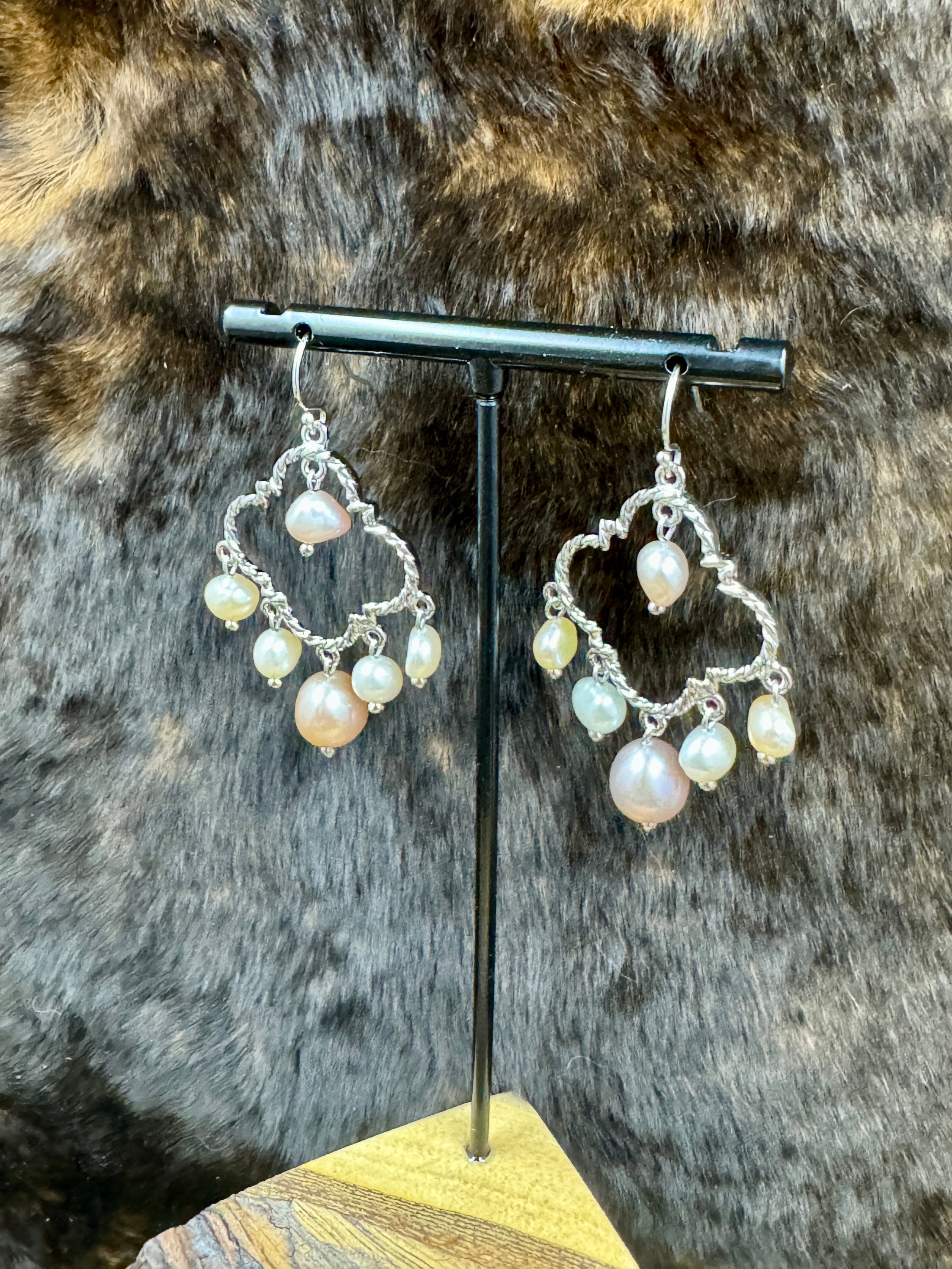 Pearl Chandelier Earrings on stand with dark fur background