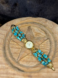 Load image into Gallery viewer, Vintage Angie Dickinson Turquoise Watch on wood block with a star on it on dark fur background
