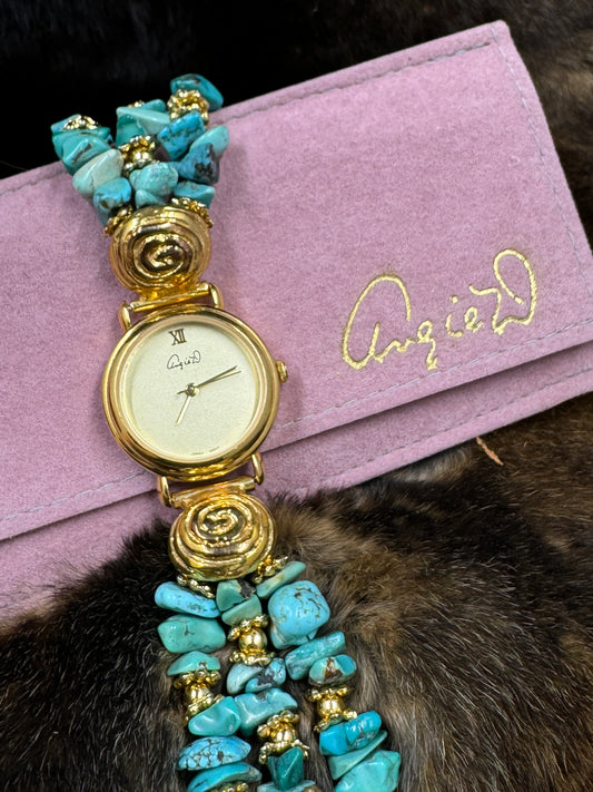 Vintage Angie Dickinson Turquoise Watch on pink pouch on dark fur background