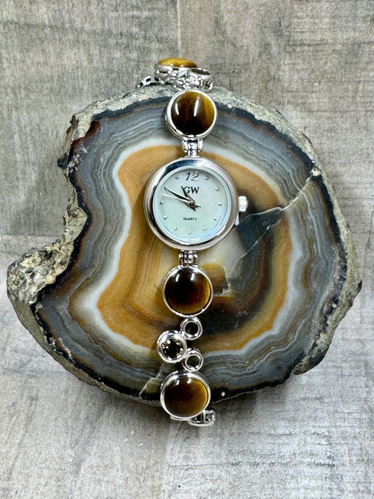 Tigers Eye and Sterling Silver Watch on Geode Rock and wood background