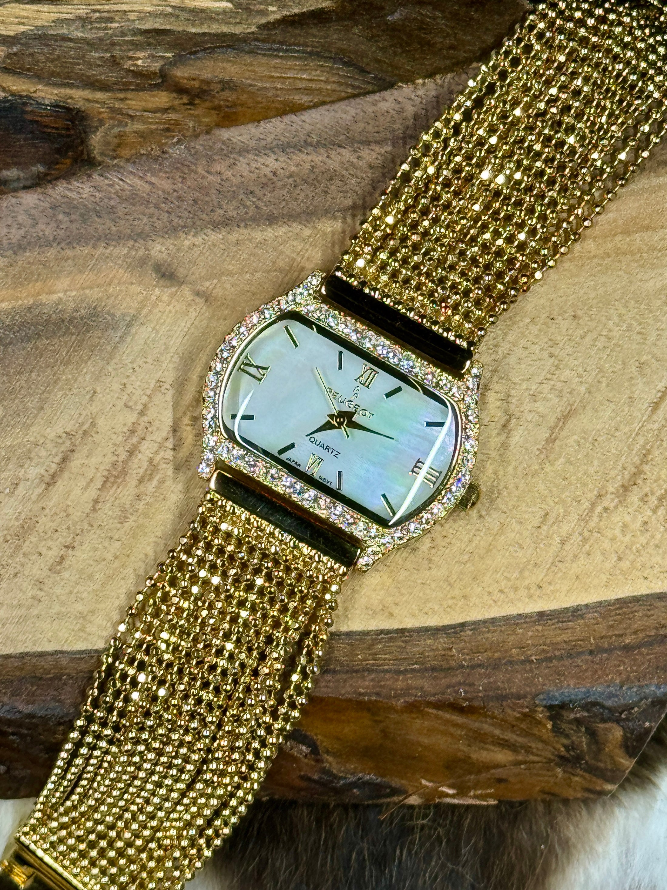 Peugeut Gold and Crystal Ladies Watch on wood background