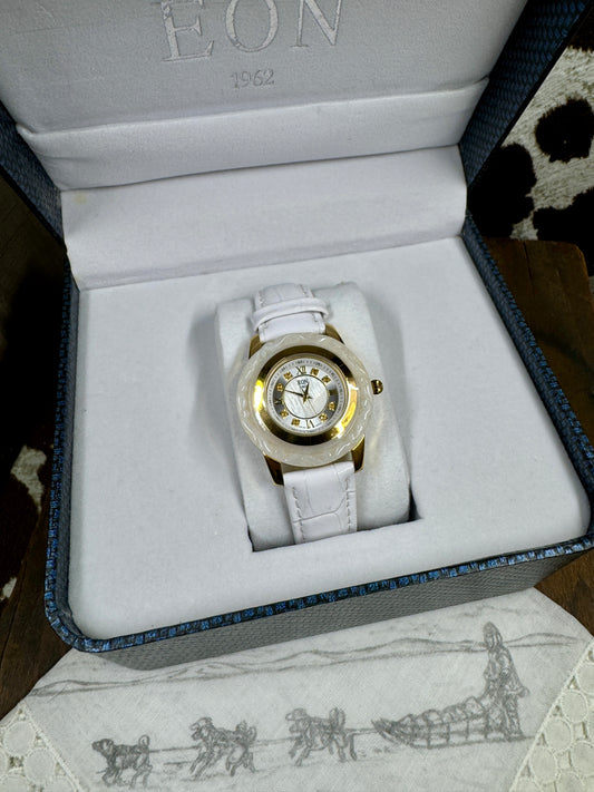 Eon 1962 White Carved Jade Ladies Watch, in the box,  laying on a hankerchief with dog sled team on it and cowhide background