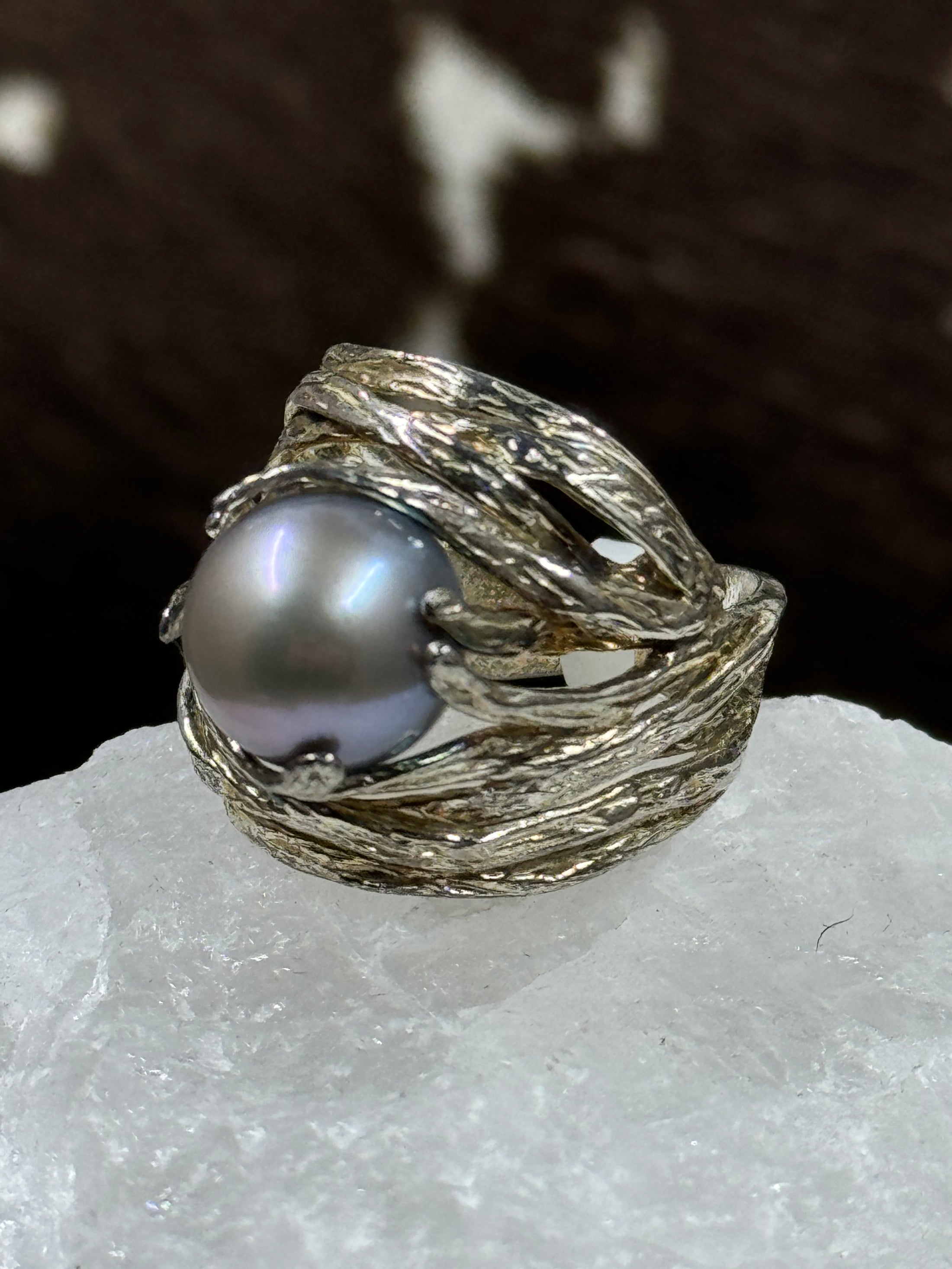 Sterling Silver and Cultured Freshwater Pearl Ring on white rock with brown background