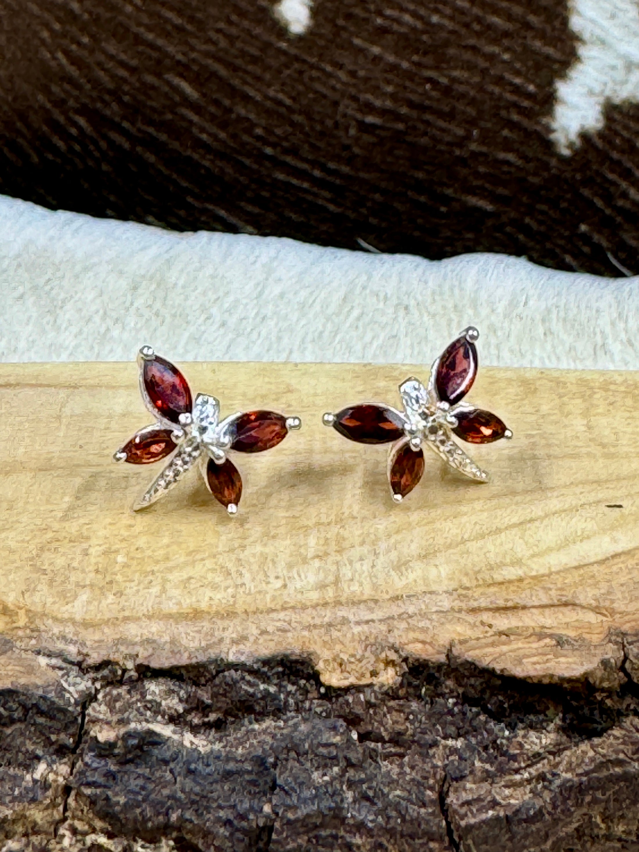 Garnet Butterfly and Sterling Earrings on wood block with cowhide background