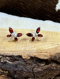 Load image into Gallery viewer, Garnet Butterfly and Sterling Earrings on wood block with cowhide background
