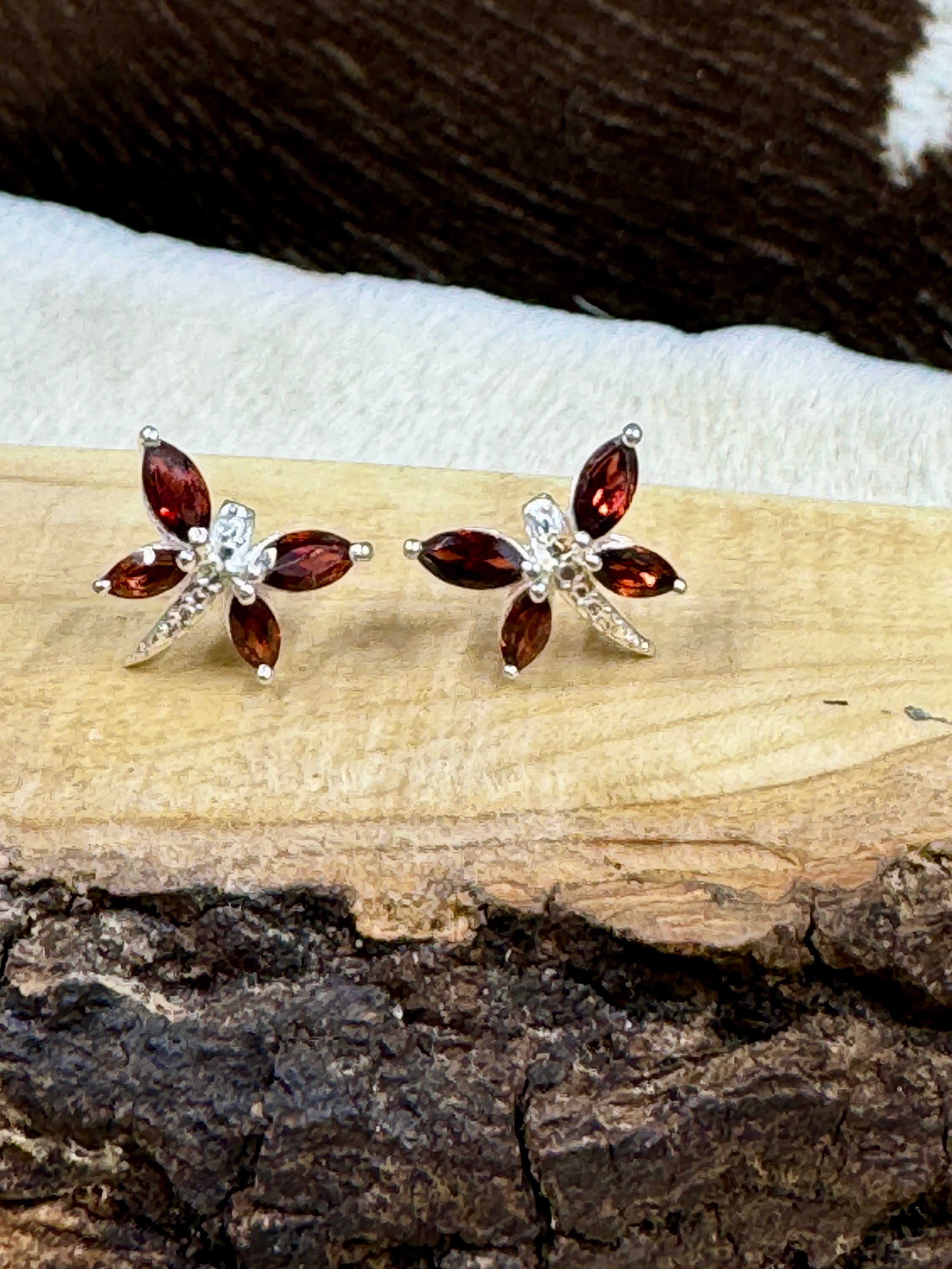 Garnet Butterfly and Sterling Earrings on wood block with cowhide background