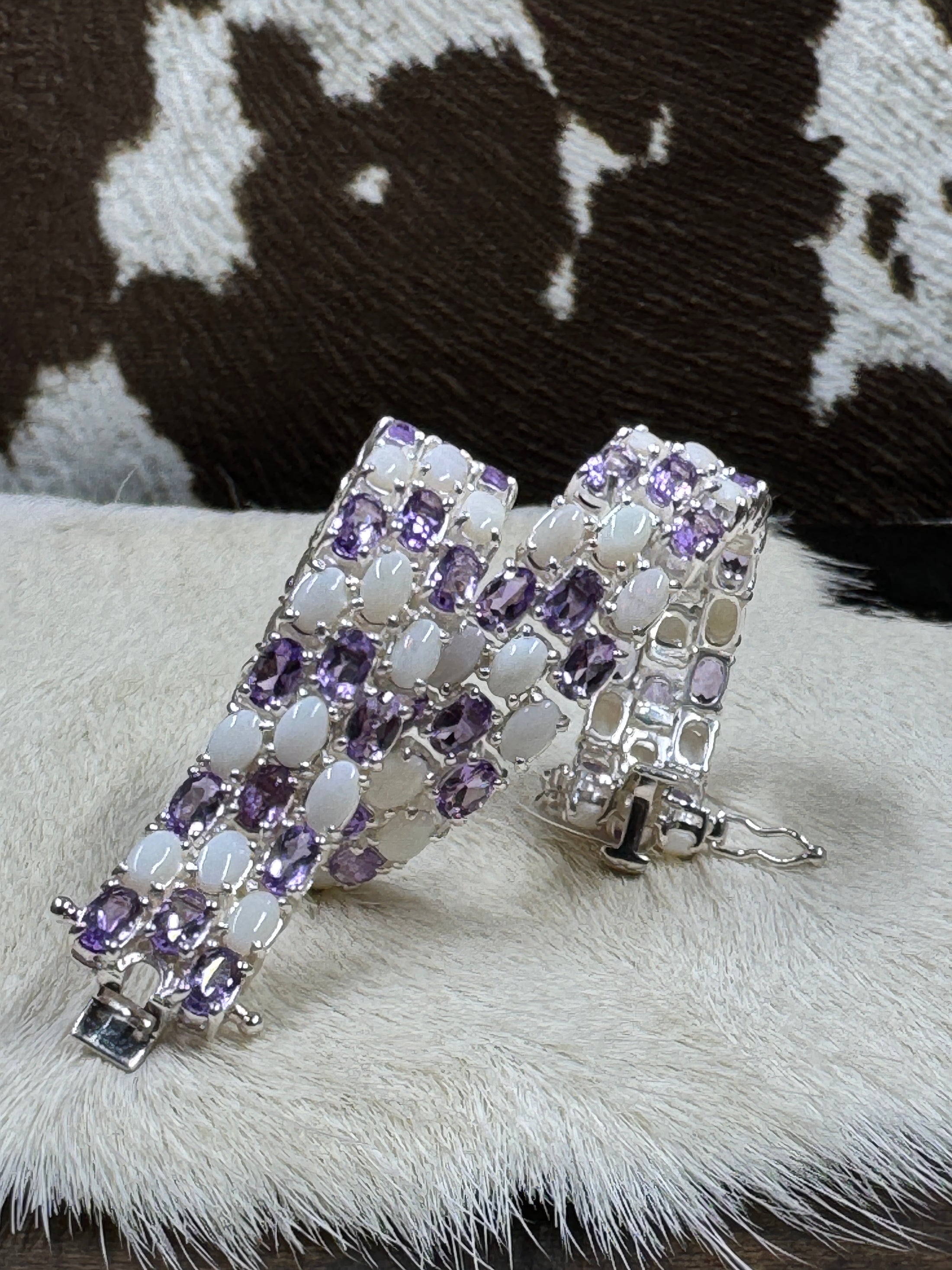 Genuine Opal and Amethyst Bracelet curled up on cowhide