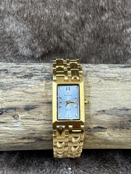 Vintage Elgin Quartz Ladies Watch on wood with fur background