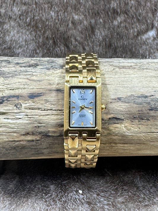 Vintage Elgin Quartz Ladies Watch on wood with fur background