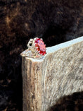 Load image into Gallery viewer, Egyptian Revival Vintage 10K Gold and Orange Sapphire Ring on moose antler with fur background
