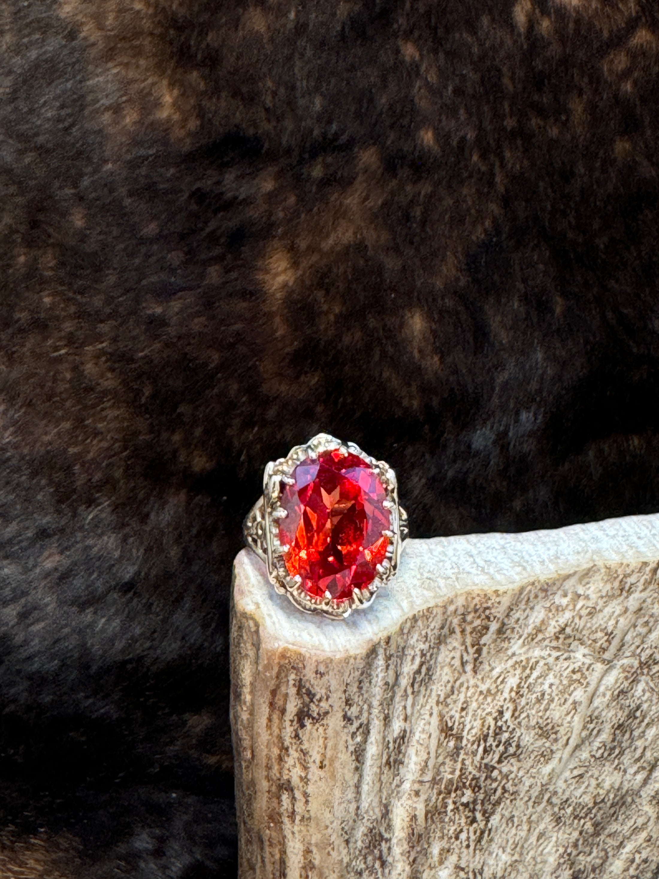 Egyptian Revival Vintage 10K Gold and Orange Sapphire Ring on moose antler with fur background